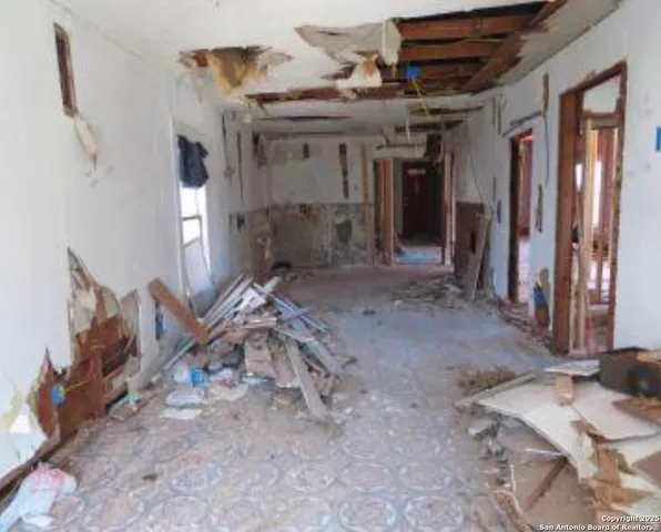 a view of a hallway with seating area