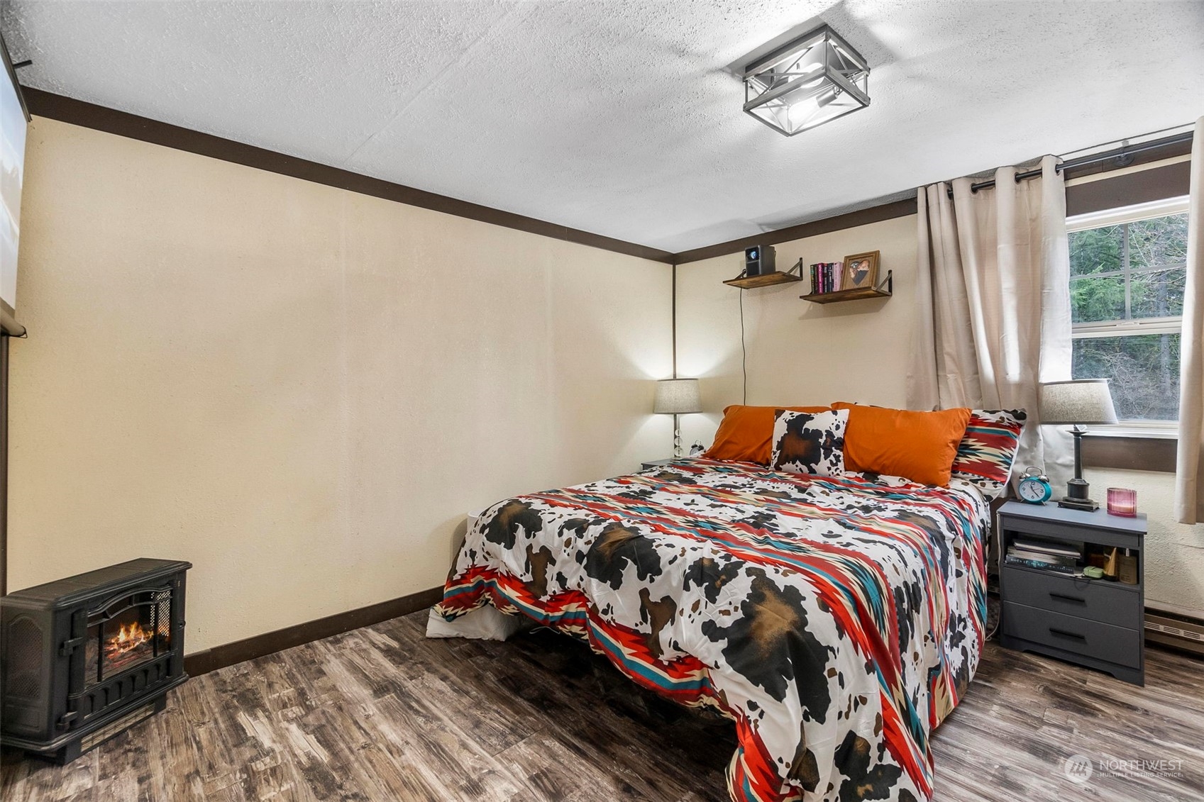 293 Logan Hill Road Chehalis, WA 98532 - Photo 13 of 36 a bedroom with a bed and wooden floor