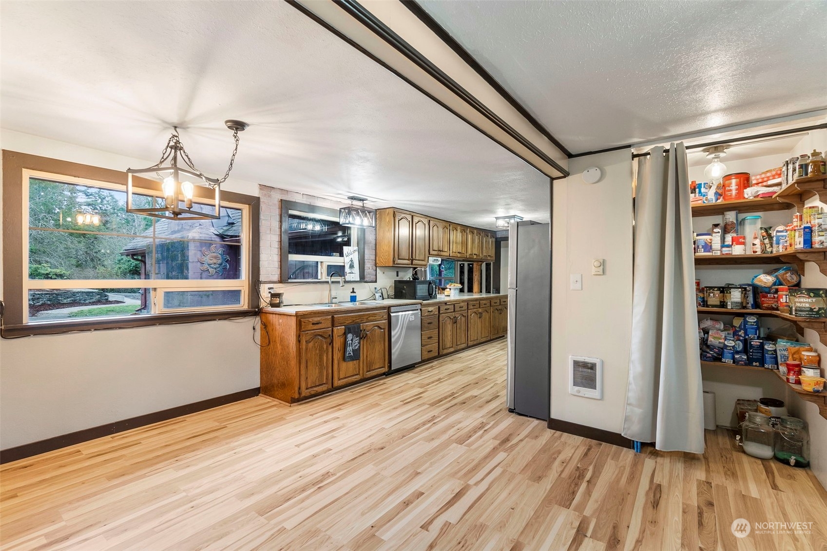 293 Logan Hill Road Chehalis, WA 98532 - Photo 8 of 36 a view of kitchen with stainless steel appliances wooden floor and window
