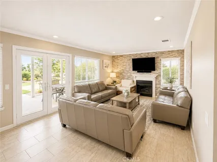 a living room with furniture a flat screen tv and a fireplace