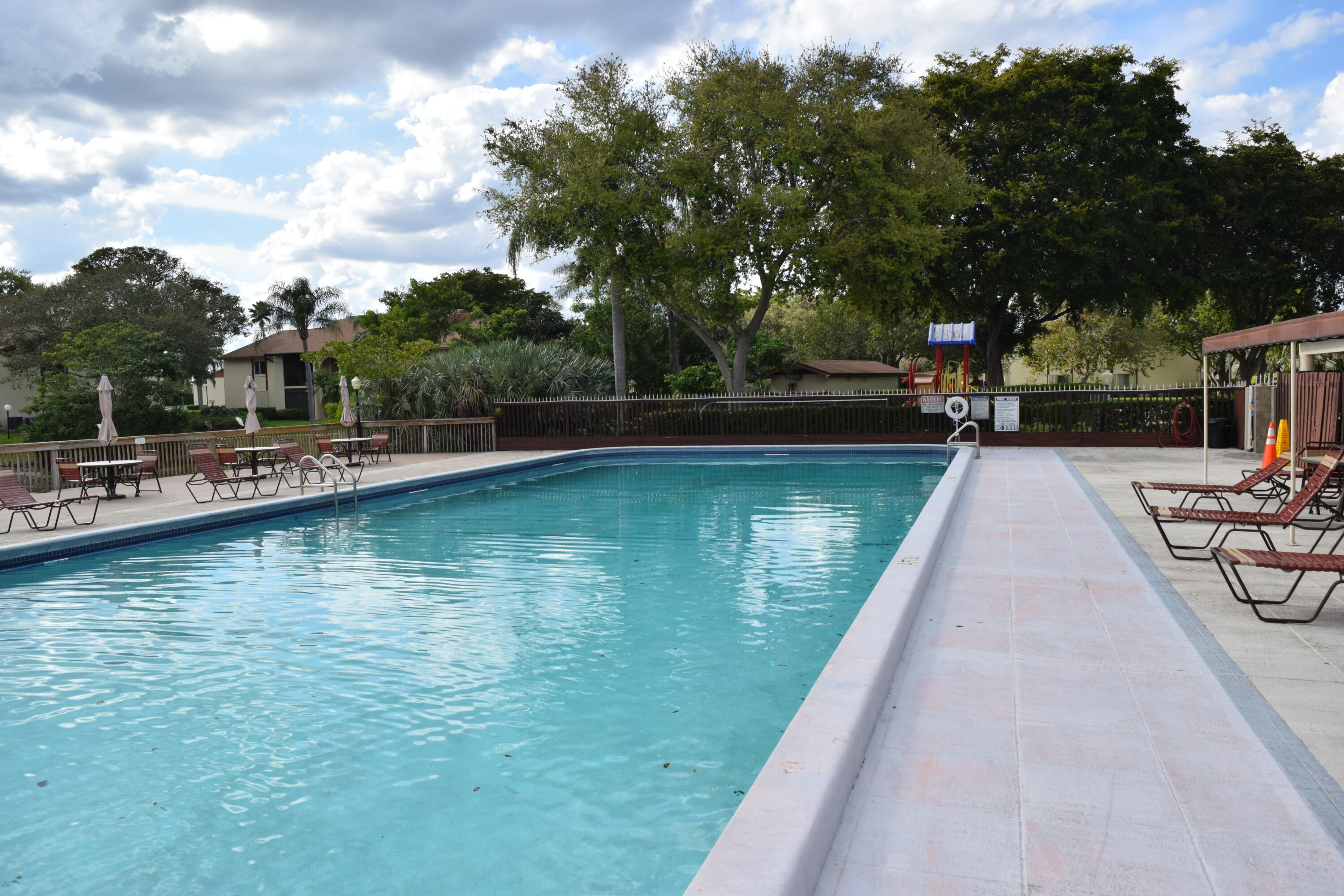 4988 Sable Pine Circle, Unit A2 West Palm Beach, FL 33417 - Photo 31 of 32 a view of swimming pool with chairs