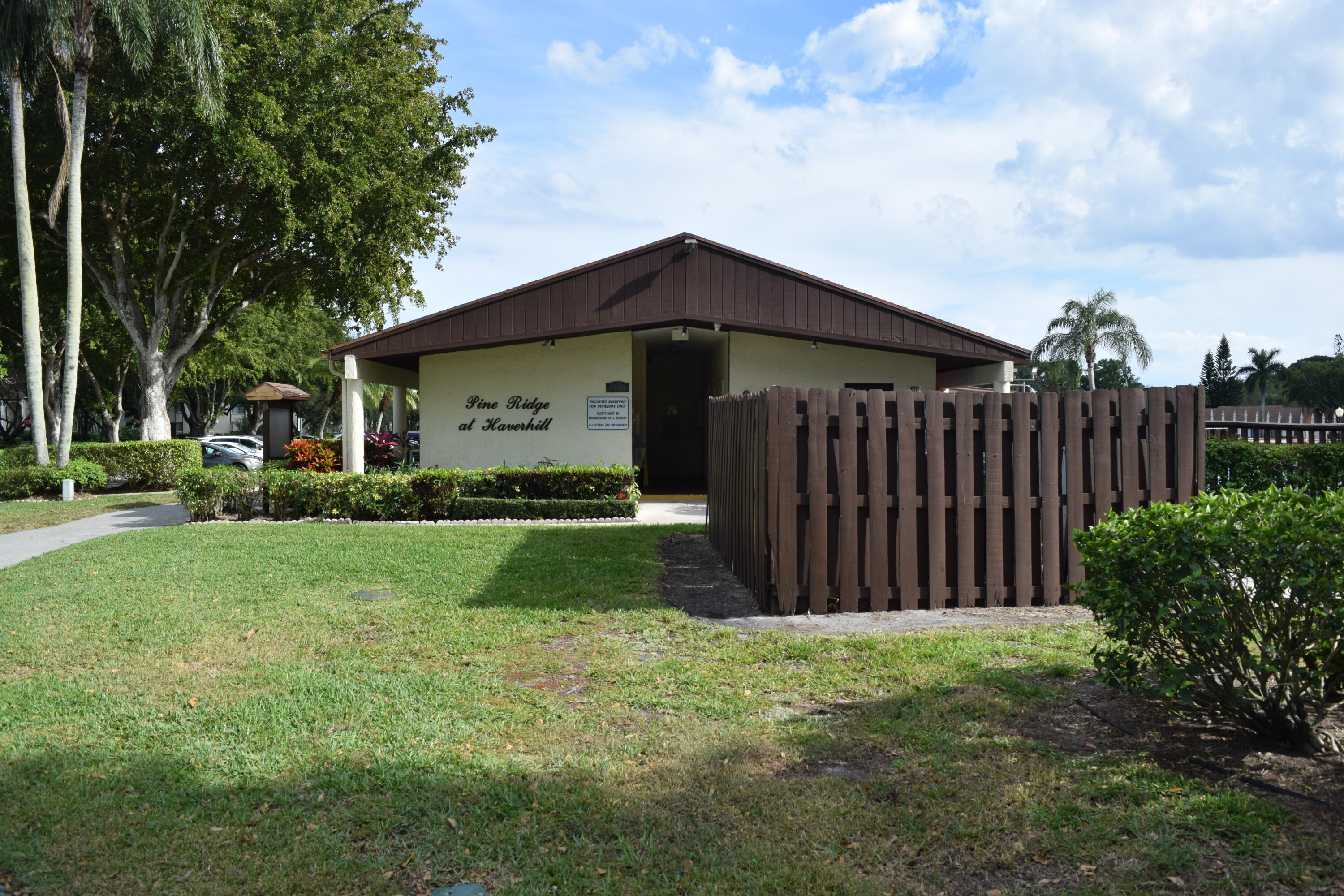 4988 Sable Pine Circle, Unit A2 West Palm Beach, FL 33417 - Photo 32 of 32 a view of a backyard with potted plants and large tree