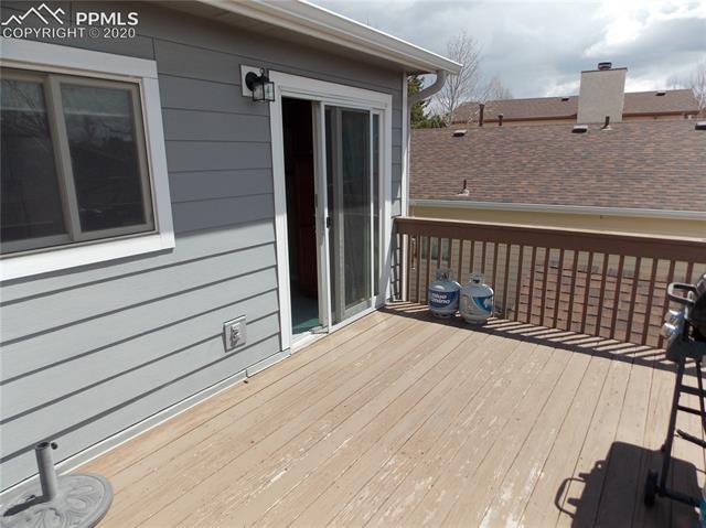 6375 Bismark Road Colorado Springs, CO 80922 - Photo 9 of 24 Amazing, large deck walks down to the back yard.
