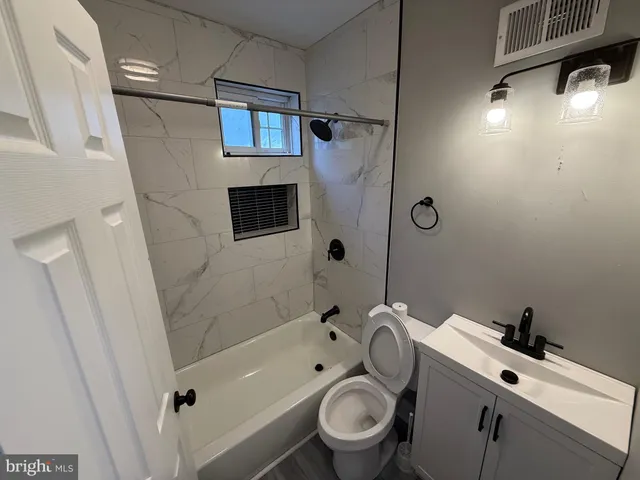 a bathroom with a toilet sink and shower