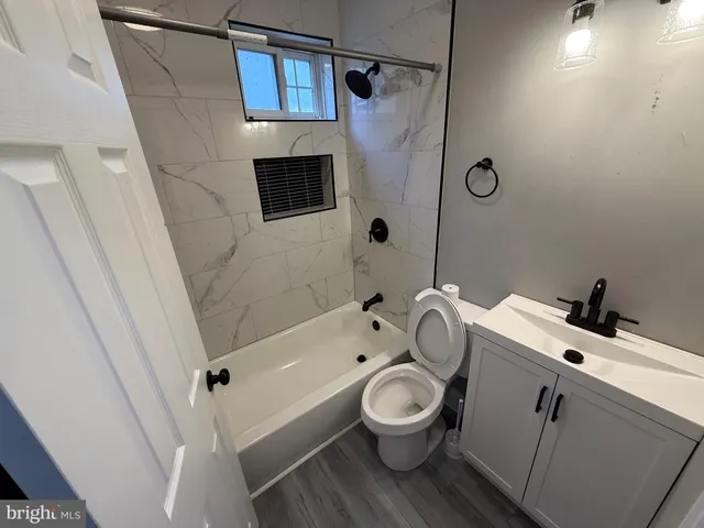 a bathroom with a toilet sink and shower