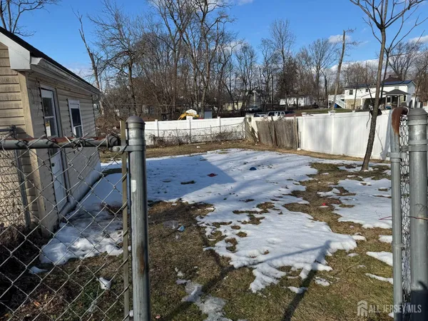 a view of a yard with snow on the road