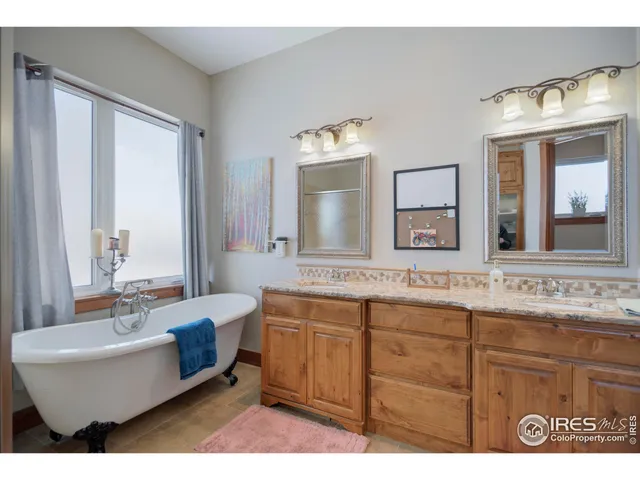 a bathroom with a double vanity sink a mirror and a