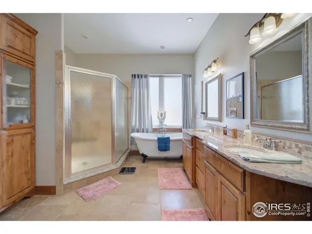 a bathroom with a tub a sink and a mirror