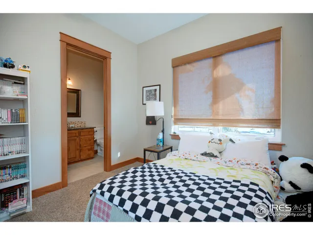 a bedroom with a bed and a painting on the wall