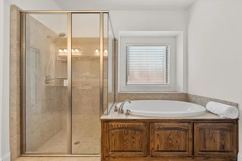 a bathroom with a tub and shower
