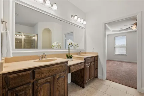 a spacious bathroom with a granite countertop sink a mirror and a