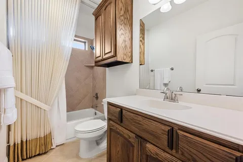 a bathroom with a sink a toilet and mirror