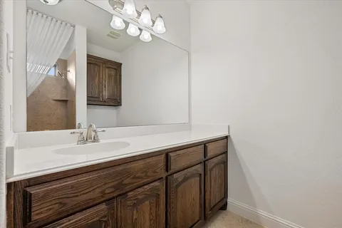 a bathroom with a sink a mirror and a light fixture