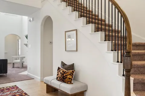 a view of hallway with stairs and furniture