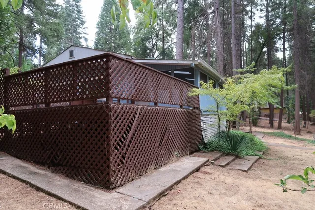 a view of a backyard with table and chairs under an umbrella