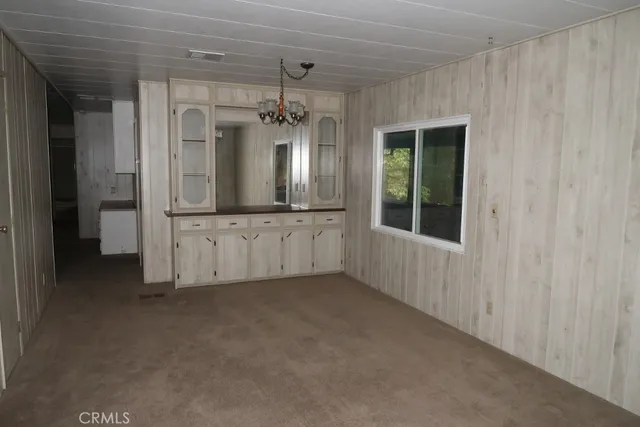 a view of a kitchen with refrigerator and mirror