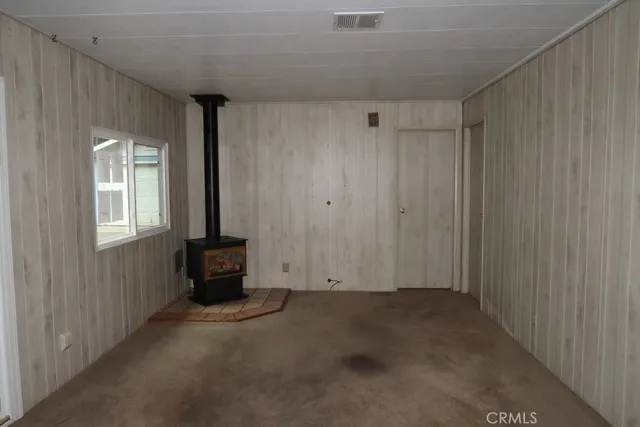 a view of a kitchen with white cabinets and refrigerator
