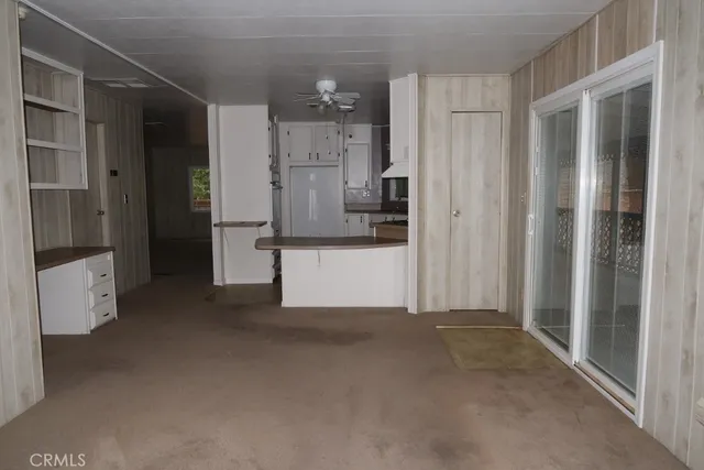 a kitchen with white cabinets and white appliances