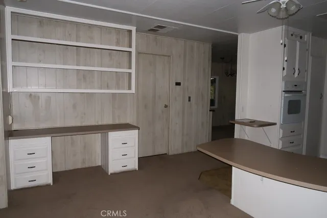 a kitchen with granite countertop white cabinets and sink