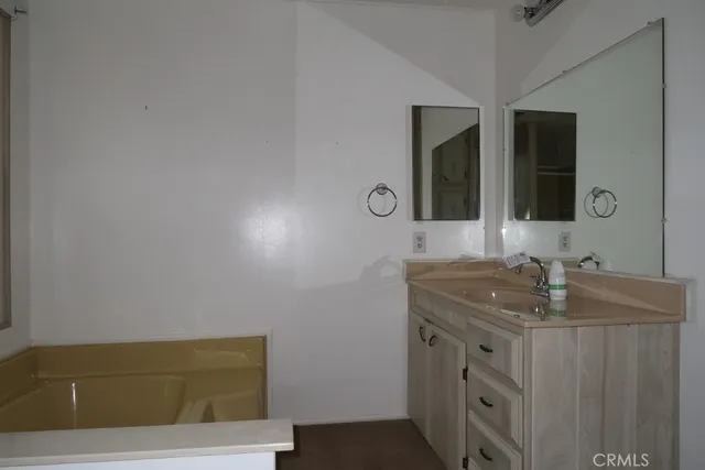 a view of an empty room with a kitchen
