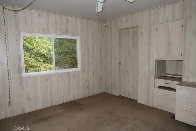 a view of an empty room with closet