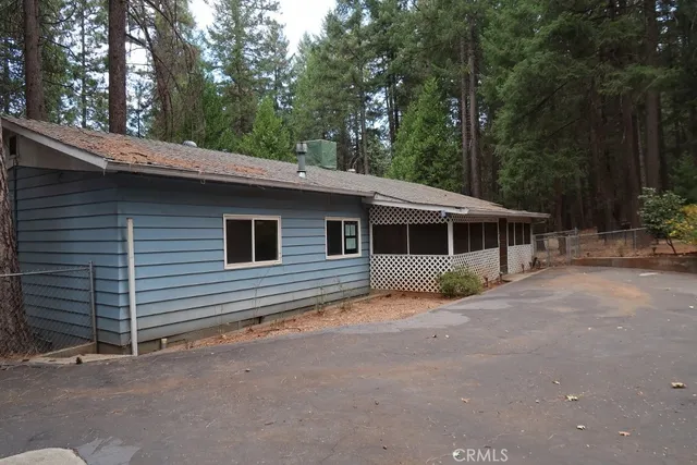 a backyard of a house with barbeque oven