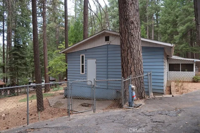 a backyard of a house with wooden floor and outdoor seating