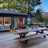 a view of a patio with a dining table and chairs under an umbrella with wooden floor