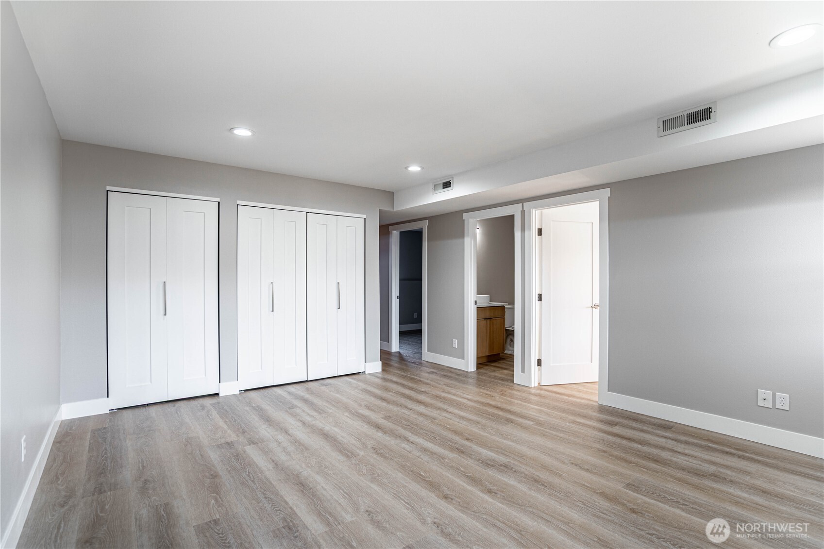 744 Wapato Way, Unit B Manson, WA 98831 - Photo 19 of 32 a view of an empty room with wooden floor