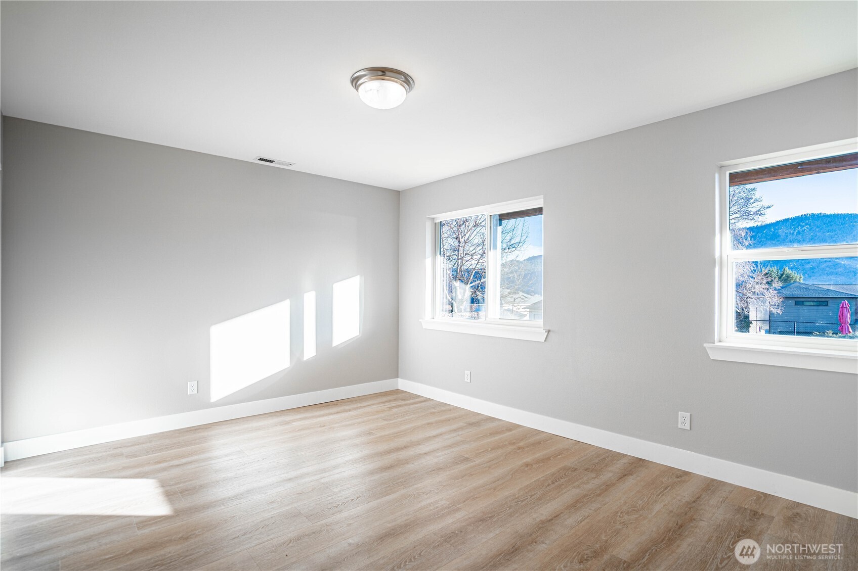 744 Wapato Way, Unit B Manson, WA 98831 - Photo 23 of 32 a view of empty room with wooden floor and fan