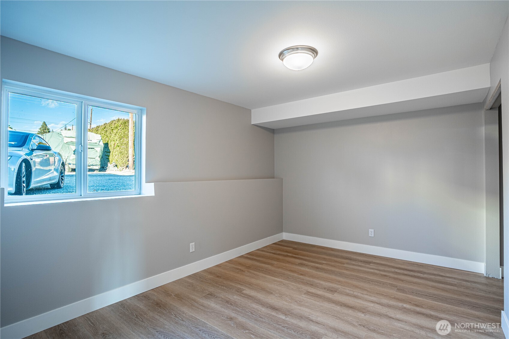 744 Wapato Way, Unit B Manson, WA 98831 - Photo 25 of 32 a view of empty room with wooden floor and fan