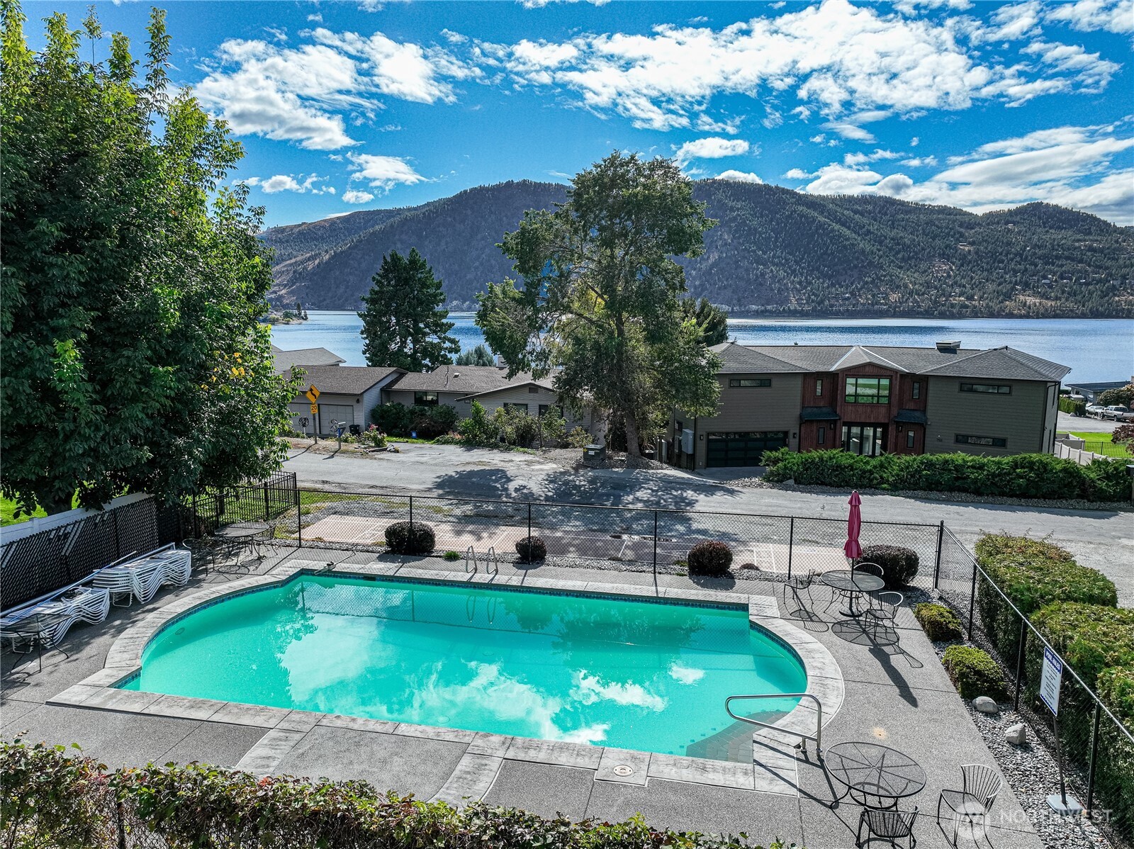 744 Wapato Way, Unit B Manson, WA 98831 - Photo 31 of 32 a view of a house with swimming pool and sitting area