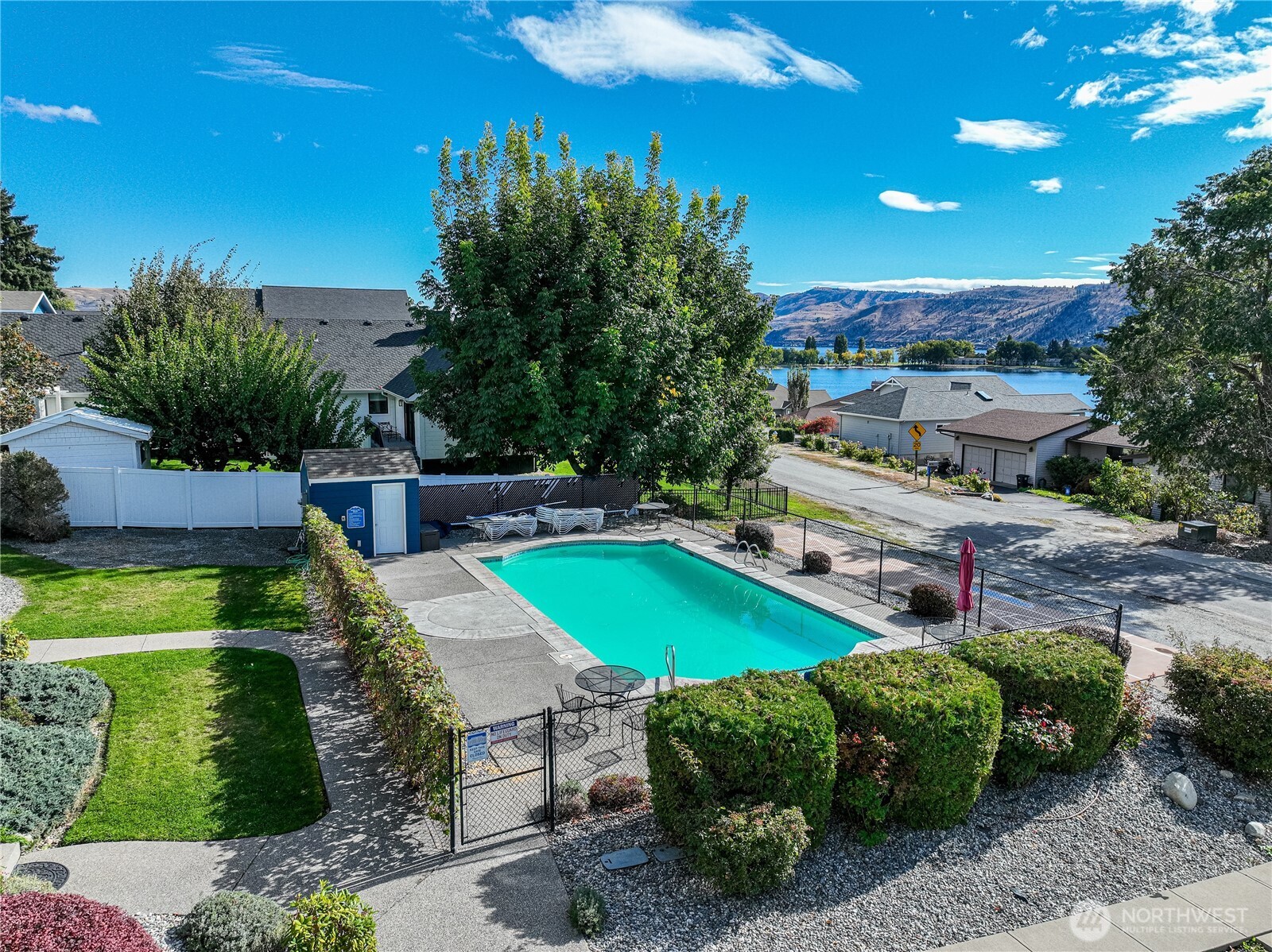 744 Wapato Way, Unit B Manson, WA 98831 - Photo 32 of 32 a swimming pool with outdoor seating and yard