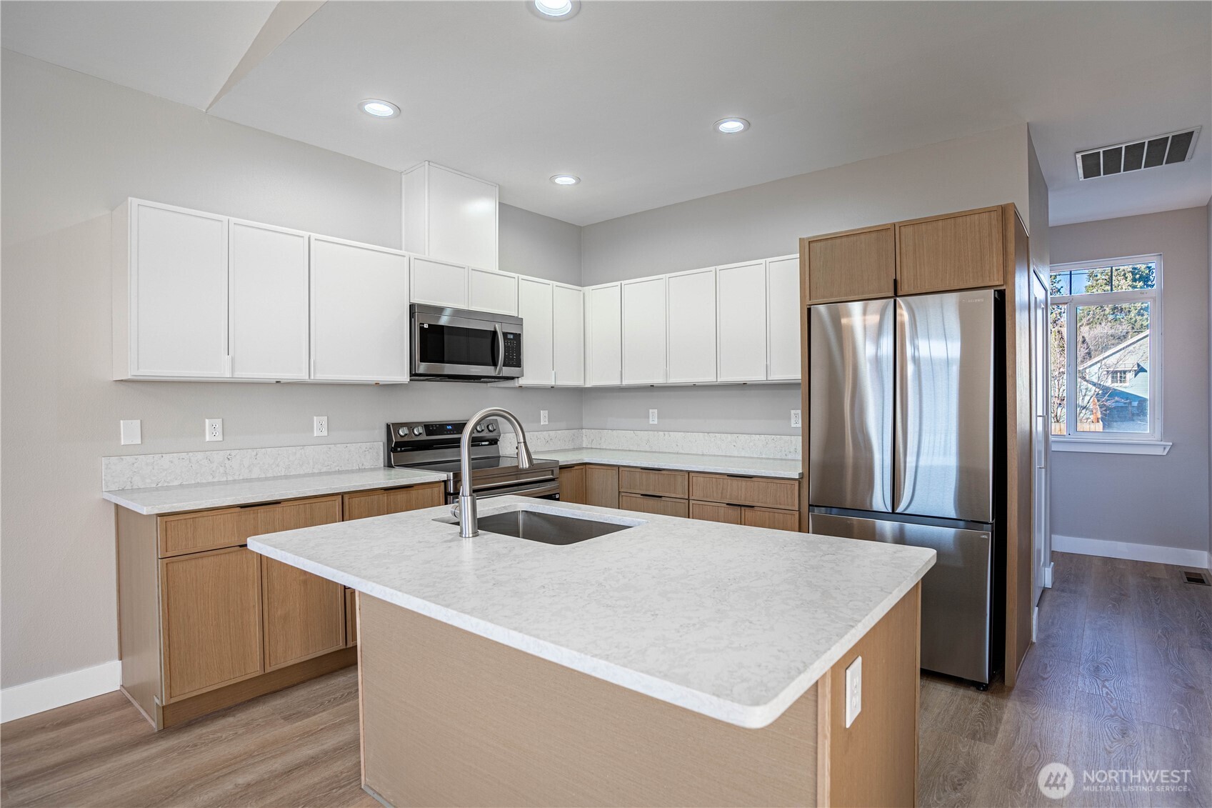 744 Wapato Way, Unit B Manson, WA 98831 - Photo 8 of 32 a kitchen with stainless steel appliances granite countertop a refrigerator a sink a stove a microwave and wooden cabinets