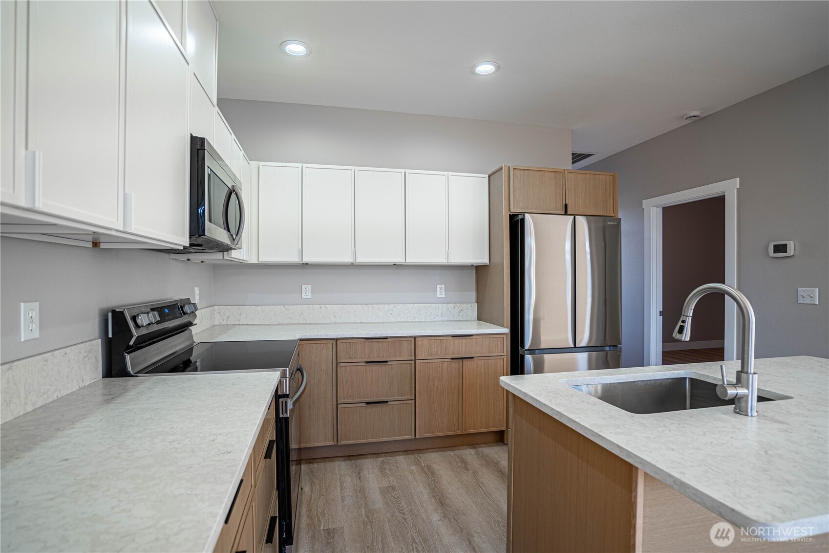 744 Wapato Way, Unit B Manson, WA 98831 - Photo 9 of 32 a kitchen with stainless steel appliances granite countertop a sink a stove and refrigerator
