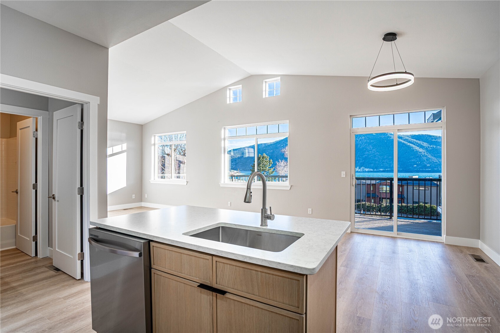 744 Wapato Way, Unit B Manson, WA 98831 - Photo 10 of 32 a kitchen with stainless steel appliances granite countertop a sink cabinets and wooden floor