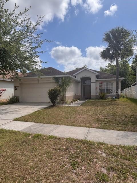 1948 Bridgeview Circle Orlando, FL 32824 - Photo 1 of 1 a front view of a house with a yard and garage
