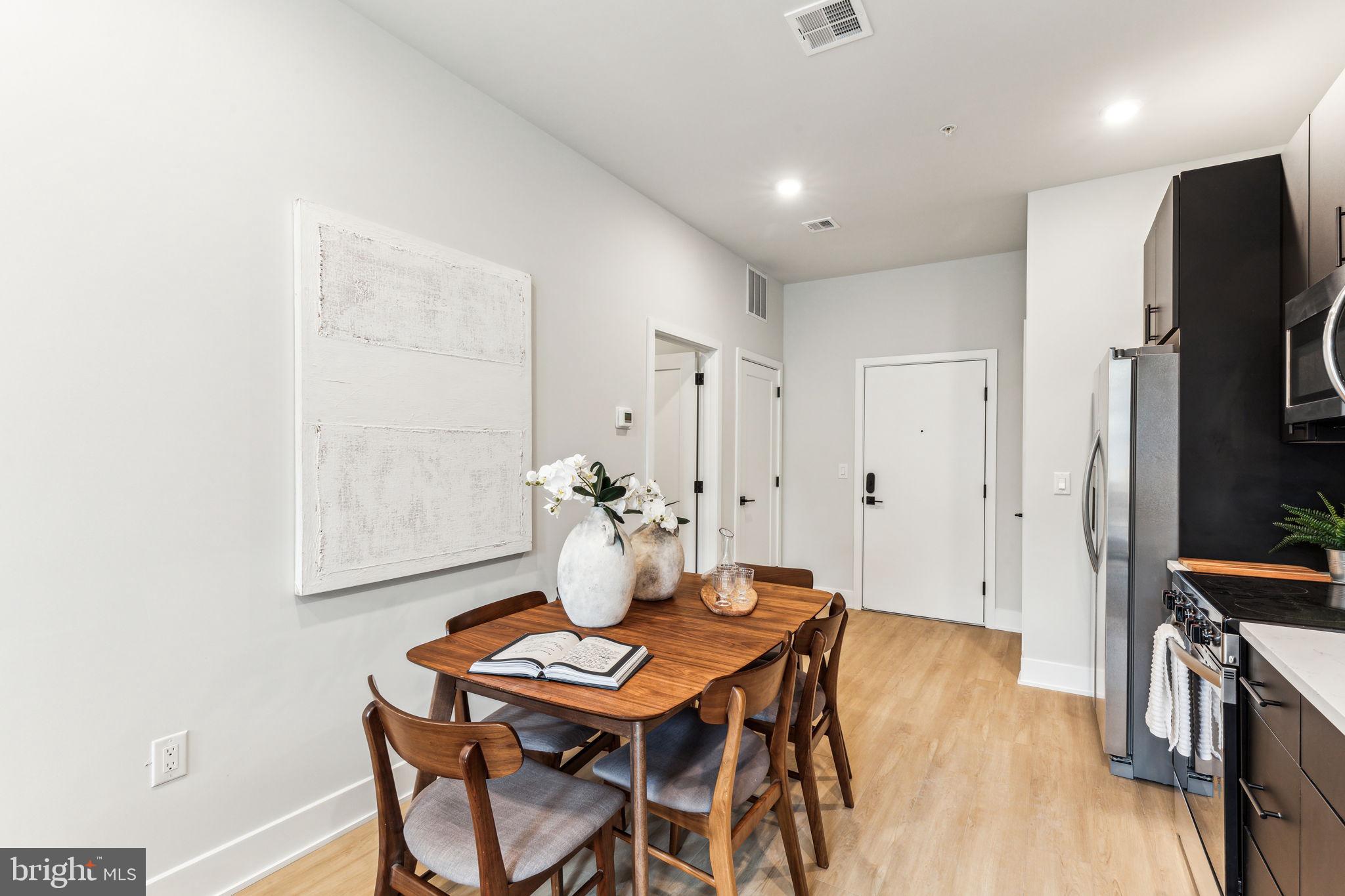 6910 Ridge Avenue, Unit 312 Philadelphia, PA 19128 - Photo 8 of 18 a view of a dining room with furniture and wooden floor