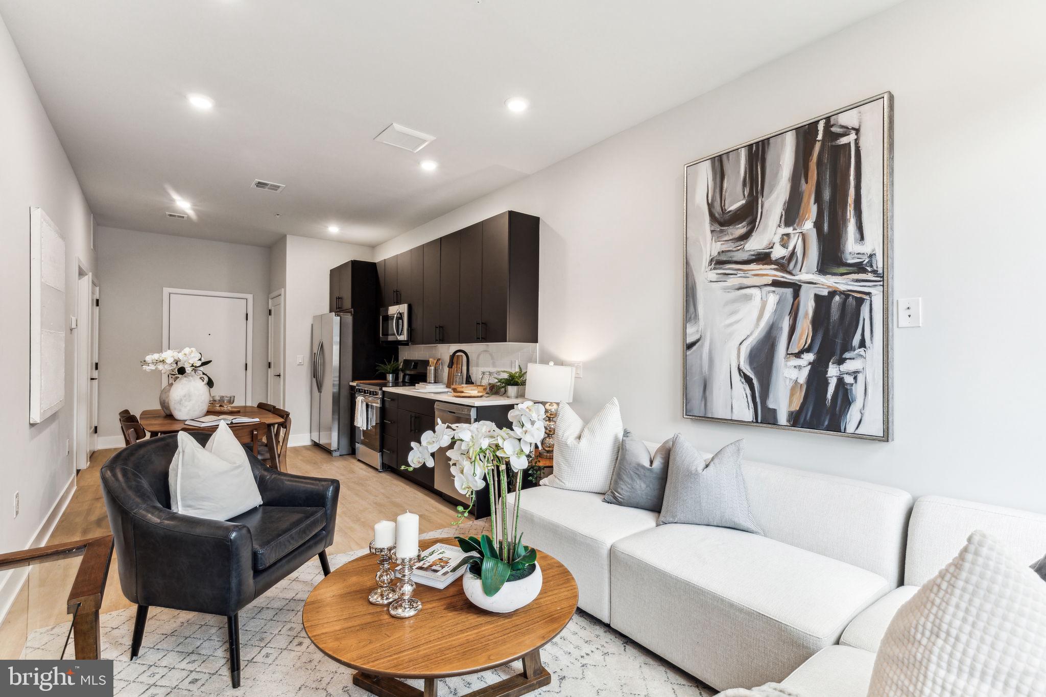 6910 Ridge Avenue, Unit 312 Philadelphia, PA 19128 - Photo 10 of 18 a living room with furniture and a kitchen