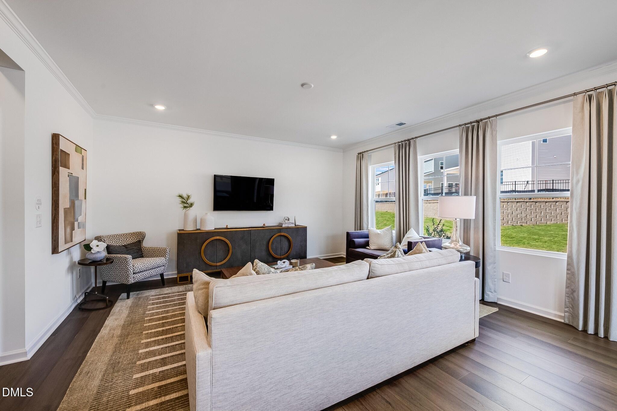1004 Red Finch Way Angier, NC 27501 - Photo 11 of 42 a living room with furniture and a flat screen tv