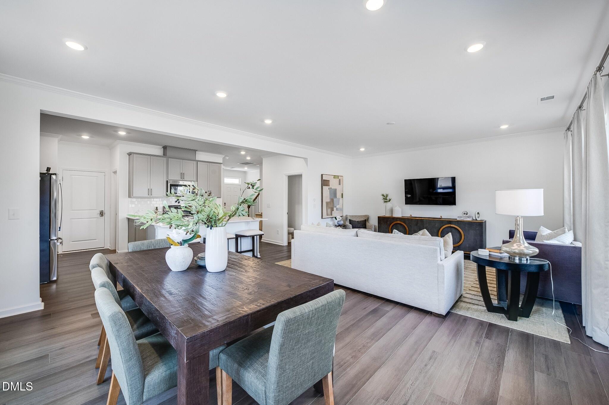 1004 Red Finch Way Angier, NC 27501 - Photo 12 of 42 a living room with furniture and a flat screen tv