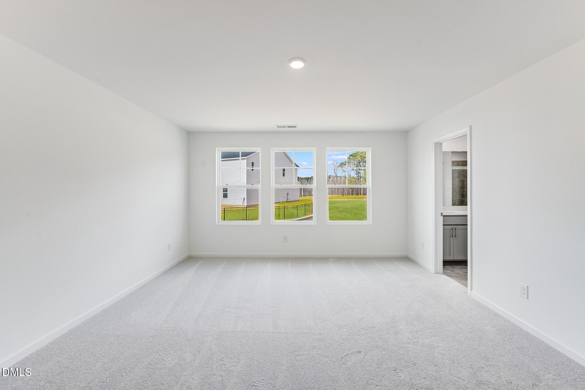 1004 Red Finch Way Angier, NC 27501 - Photo 14 of 42 an empty room with a empty space and windows
