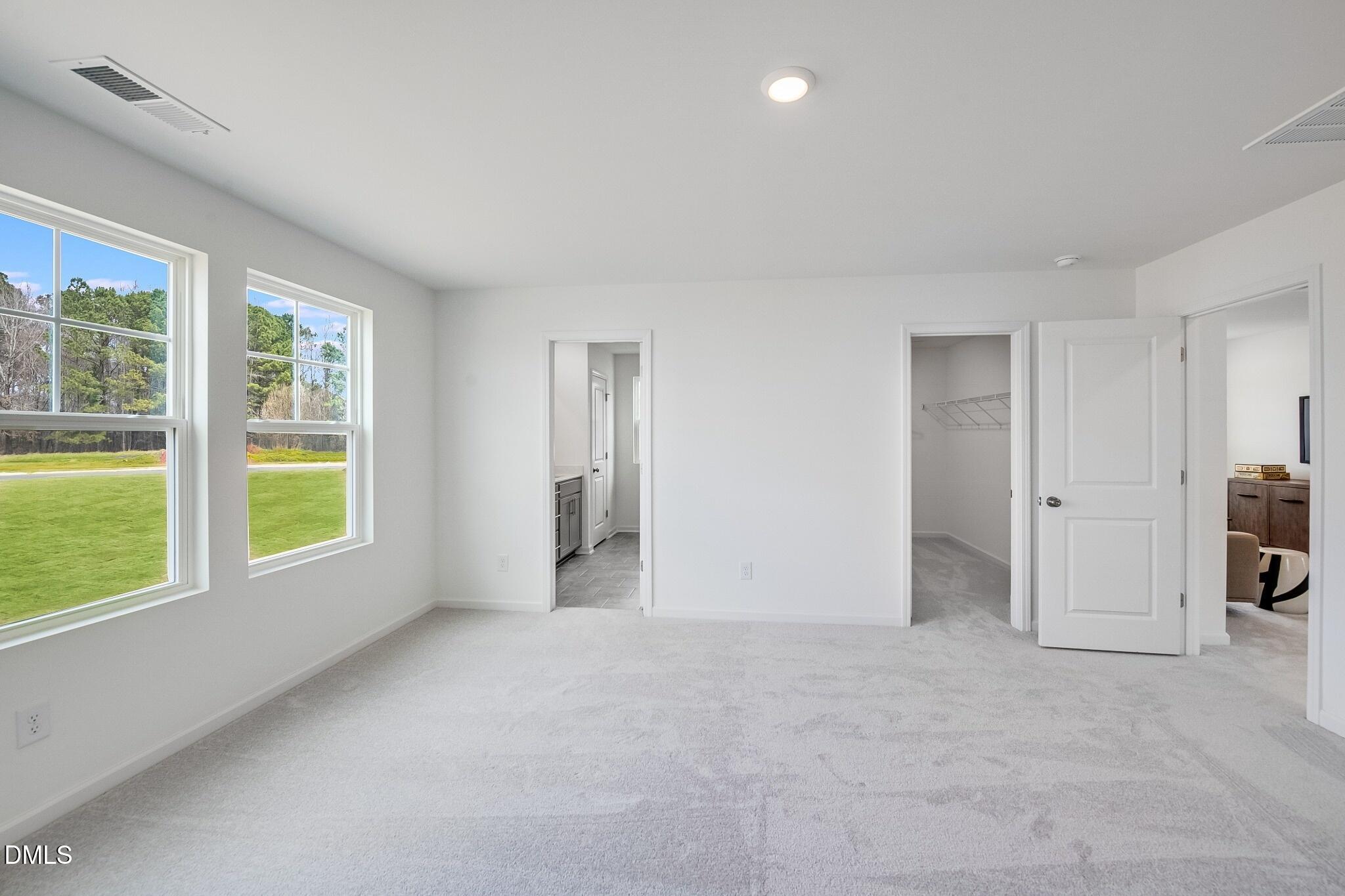 1004 Red Finch Way Angier, NC 27501 - Photo 15 of 42 a view of an empty room with a window and a kitchen