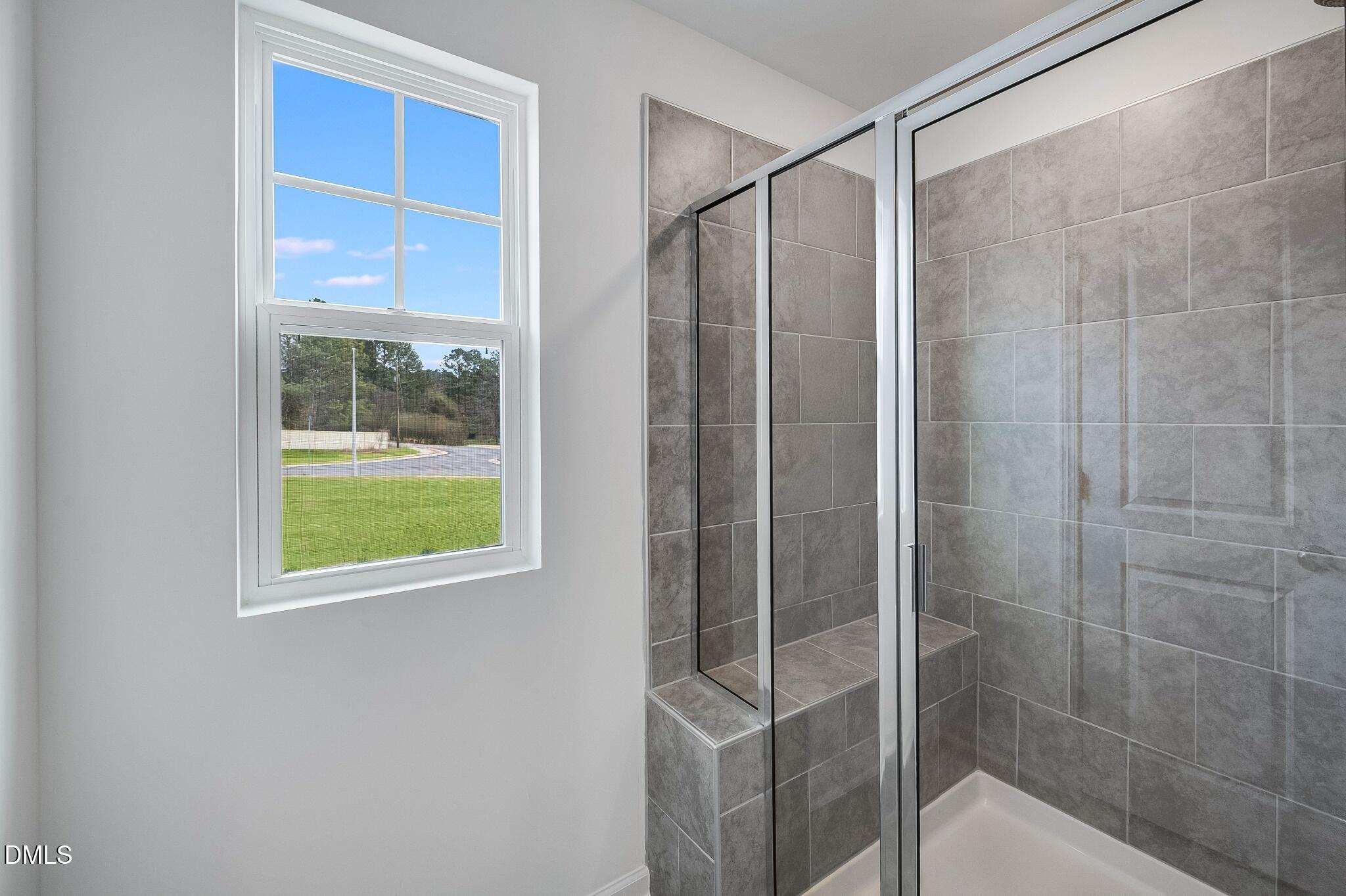 1004 Red Finch Way Angier, NC 27501 - Photo 18 of 42 a bathroom with a shower and a window