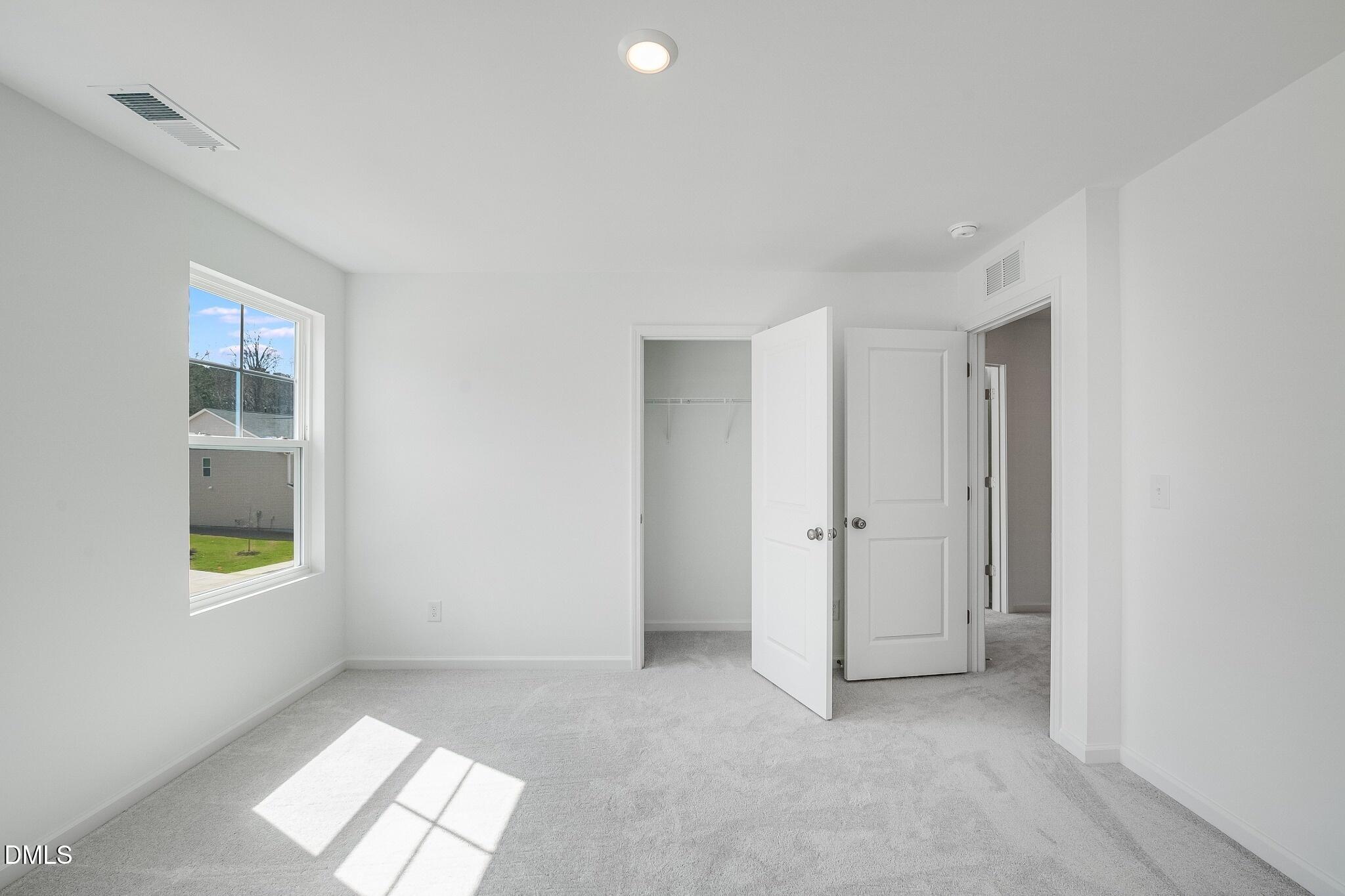 1004 Red Finch Way Angier, NC 27501 - Photo 23 of 42 an empty room with windows