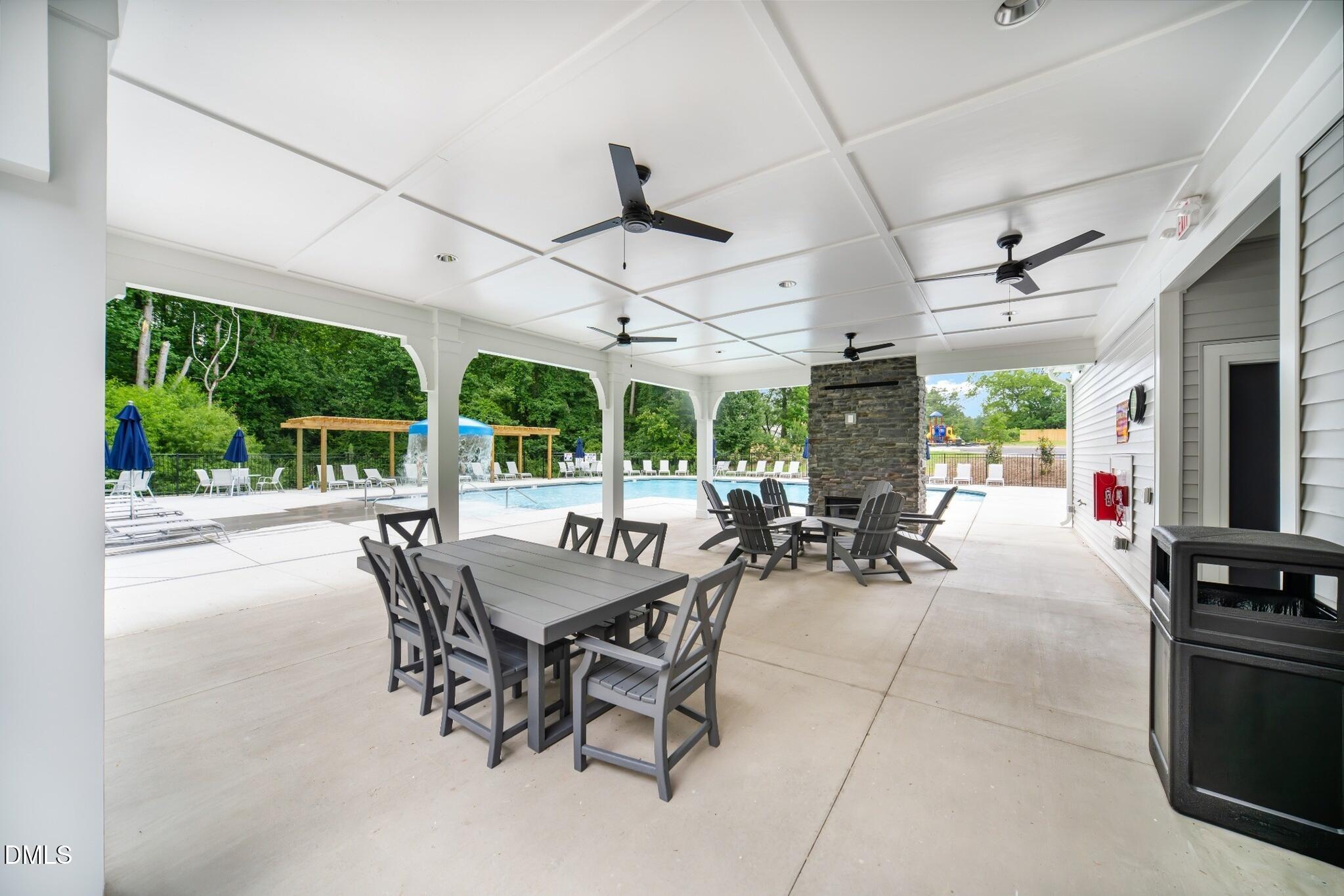 1004 Red Finch Way Angier, NC 27501 - Photo 26 of 42 a view of a patio with a table and chairs and potted plants