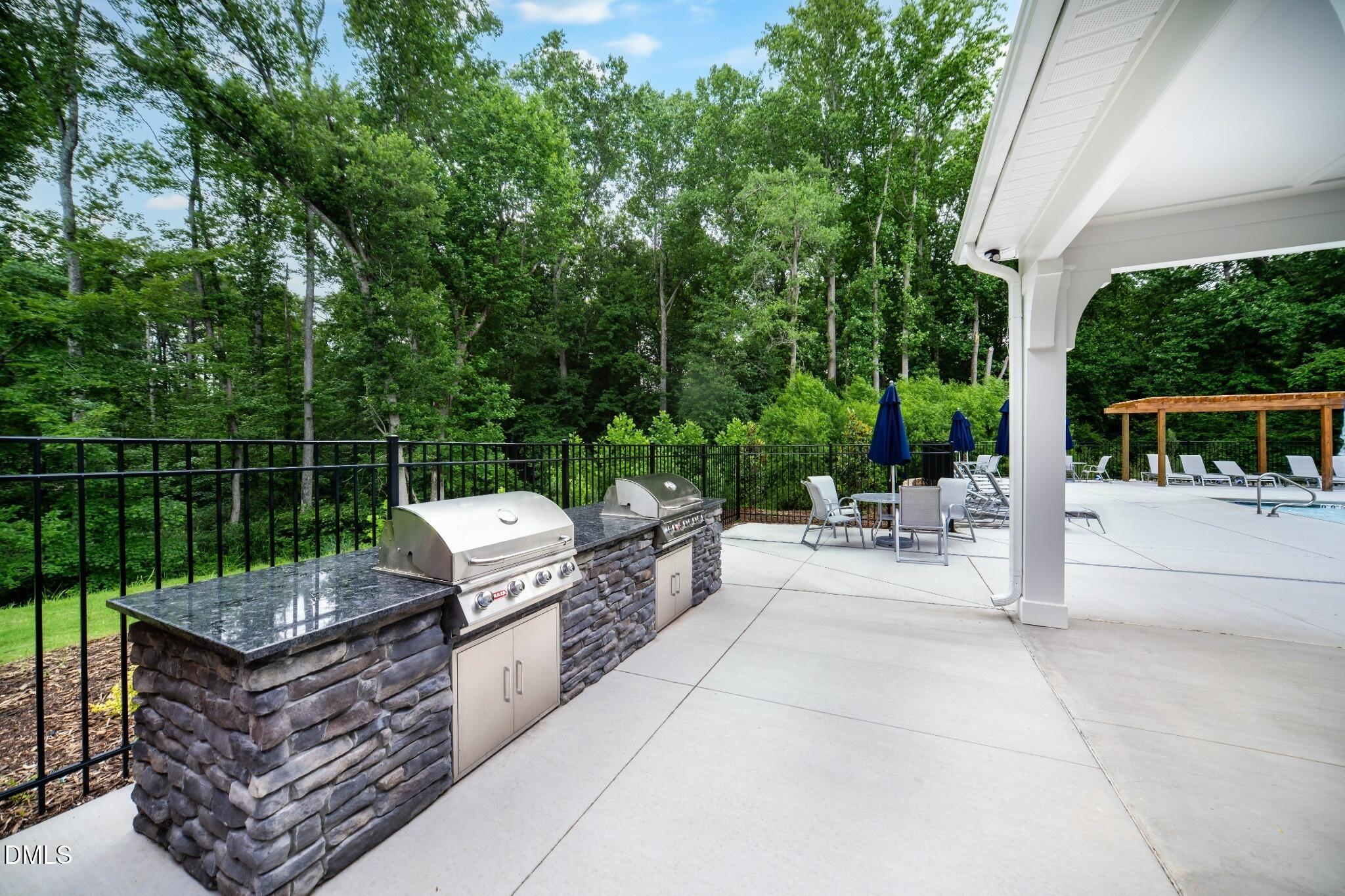 1004 Red Finch Way Angier, NC 27501 - Photo 27 of 42 a view of a patio with couches table and chairs potted plants with large tree