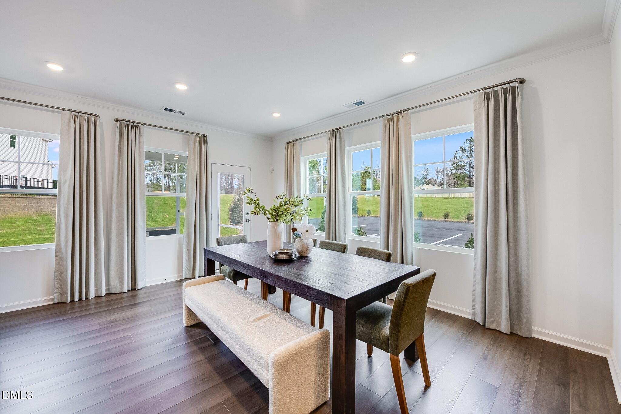 1004 Red Finch Way Angier, NC 27501 - Photo 9 of 42 a view of a dining room with furniture window and wooden floor