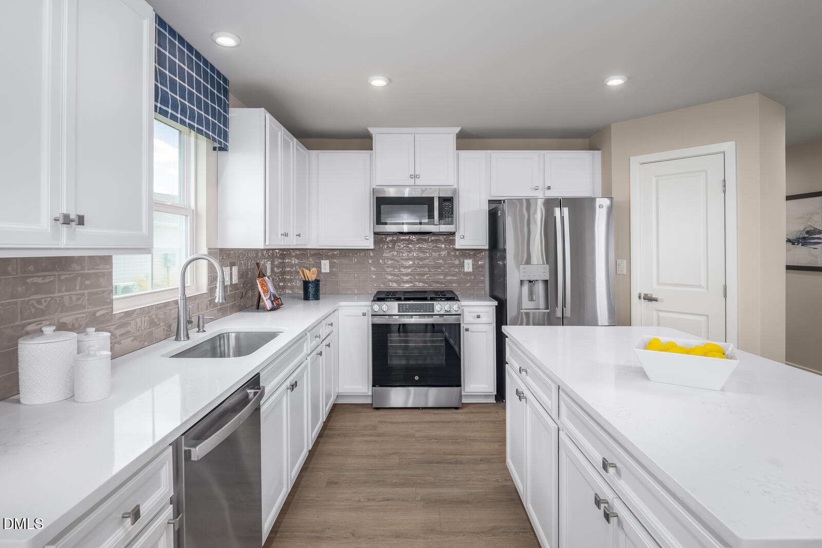 500 Country Side Way Fuquay-Varina, NC 27526 - Photo 2 of 22 a kitchen with stainless steel appliances a stove refrigerator sink and cabinets