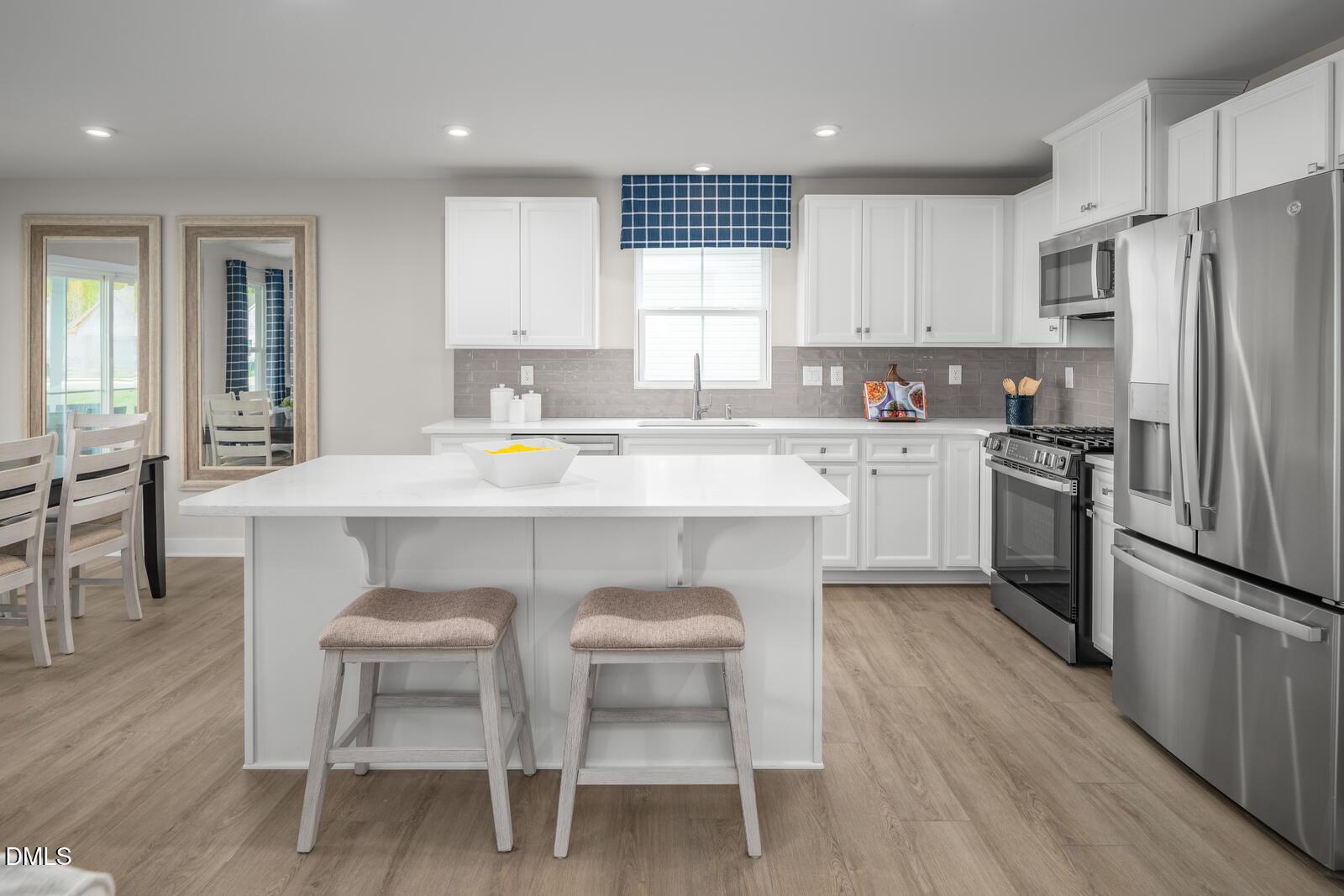 500 Country Side Way Fuquay-Varina, NC 27526 - Photo 4 of 22 a kitchen with a sink stove cabinets and wooden floor